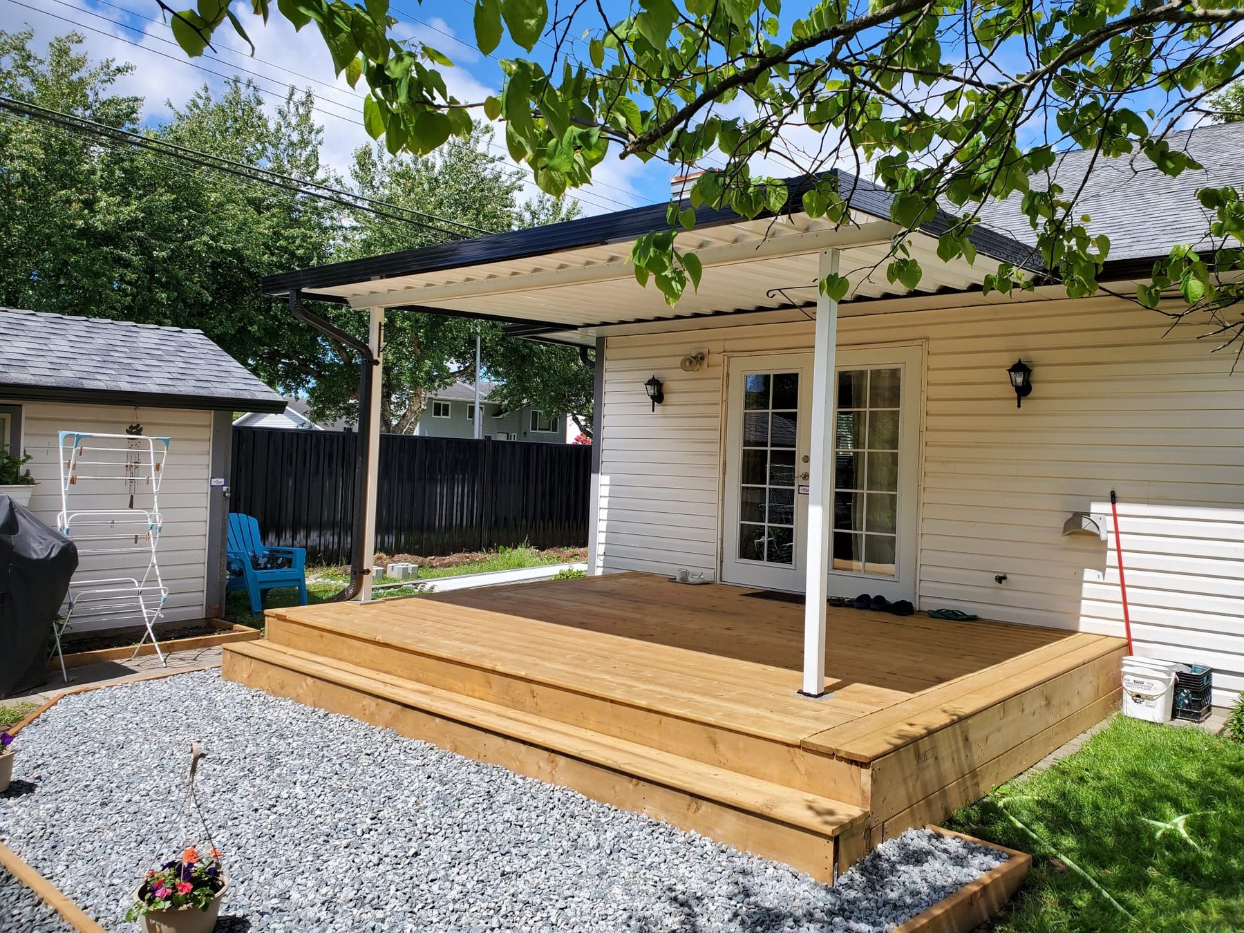 Heavy-duty white aluminum patio cover over a new cedar deck